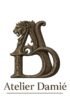 Atelier Damié logo featuring a bronze lion and intertwined A and D letters above the brand name